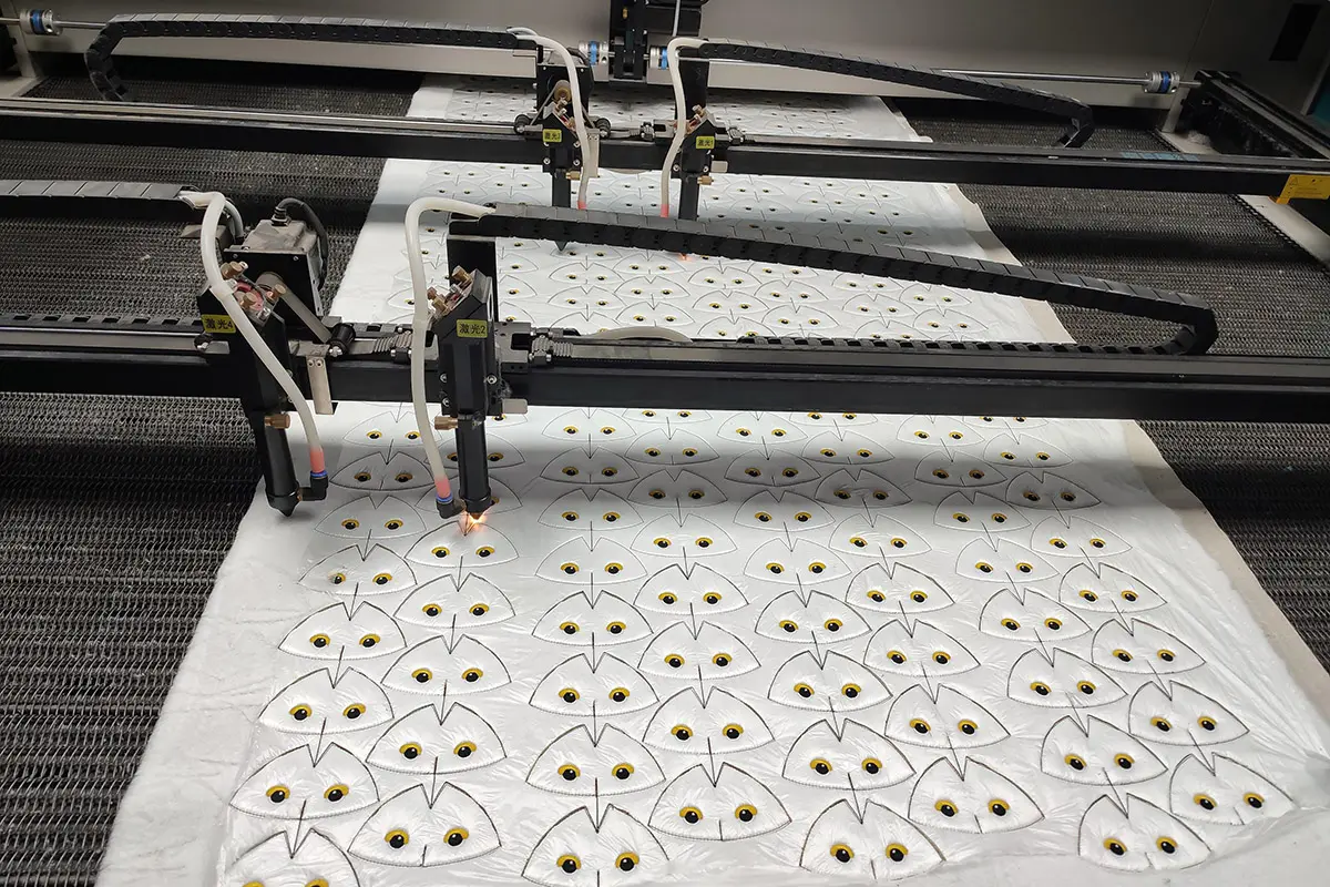 Laser cutting plush fabric pieces with printed eyes for custom plush production