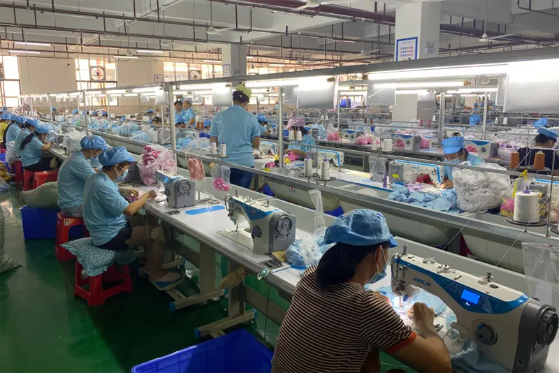 WisePlush plush toy sewing workshop line with workers sewing plush parts