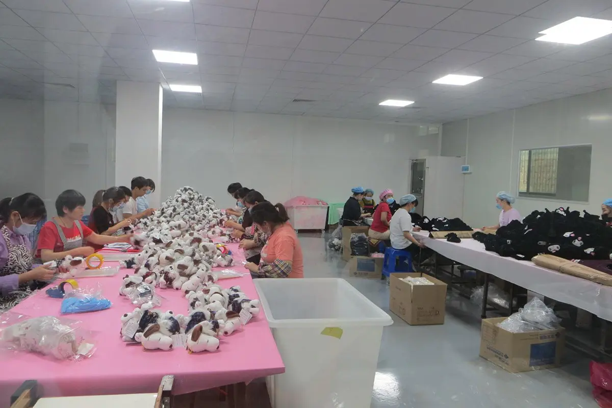 Plush toy handwork finishing room with workers checking small plush pieces