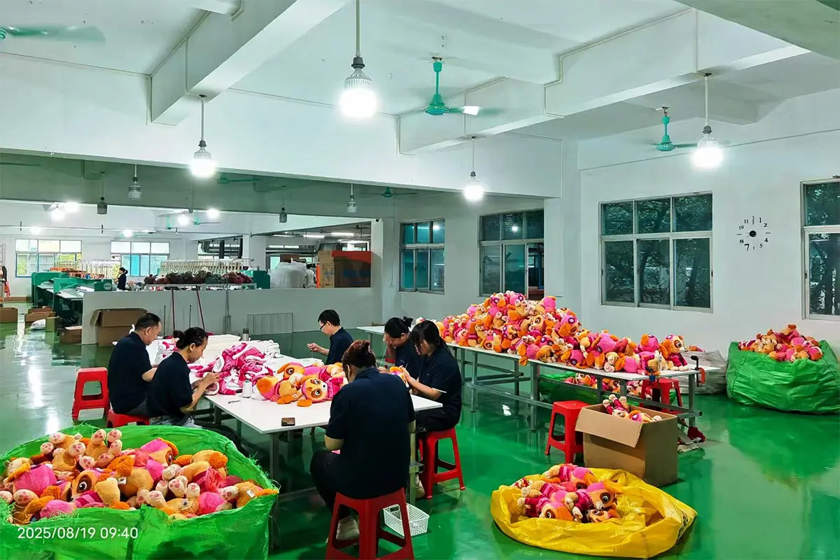 Workers checking and sorting colorful plush toys in the final inspection area