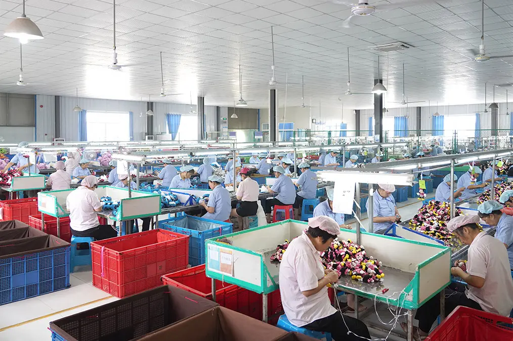 Plush toy production line quality check with workers finishing bulk plush toys
