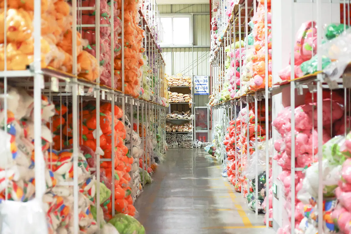Plush fabric rolls and materials organized in a factory warehouse