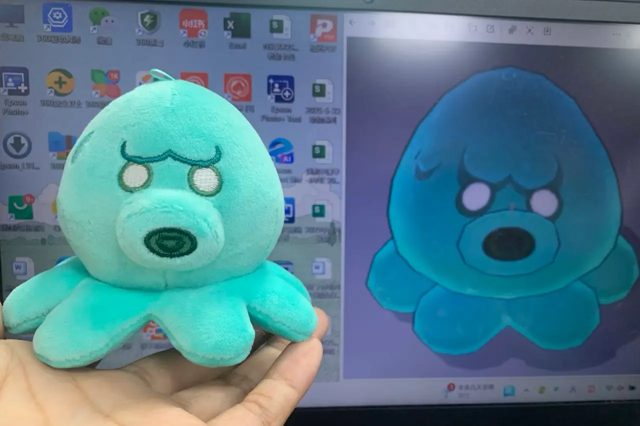 turquoise octopus plush sample with embroidered face beside artwork