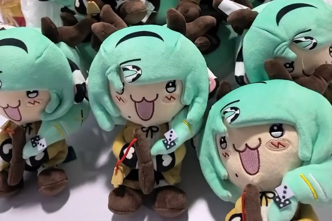 Green hair anime character plush samples in production with embroidered expressions