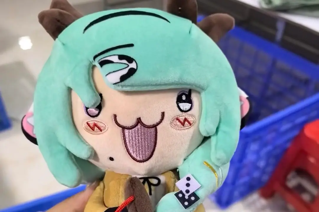 Green hair anime plush doll with embroidered eyes, mouth, blush, and face details