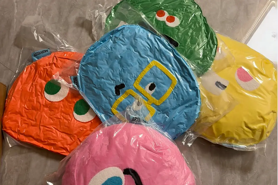 Round character plush pillows sealed in compression bags for packing