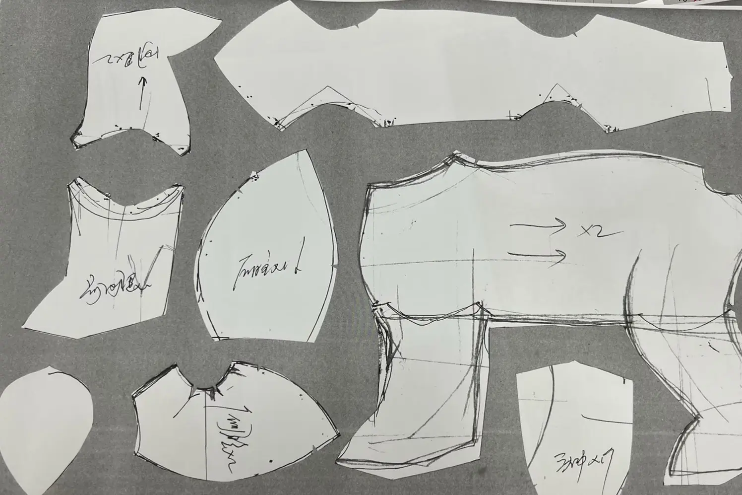 Paper pattern pieces used for plush toy cutting and sewing placement