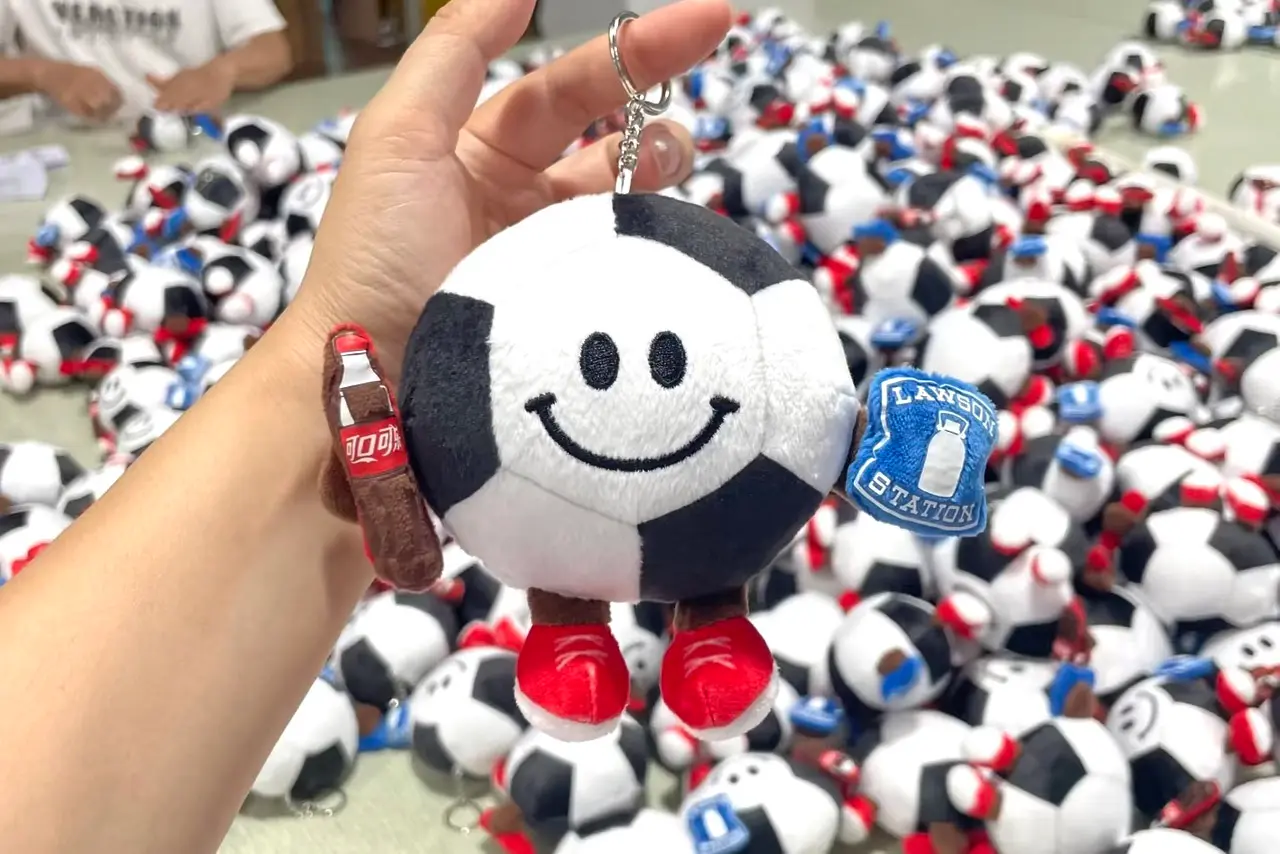 Soccer ball plush keychain bulk production with finished pieces in the WisePlush workshop