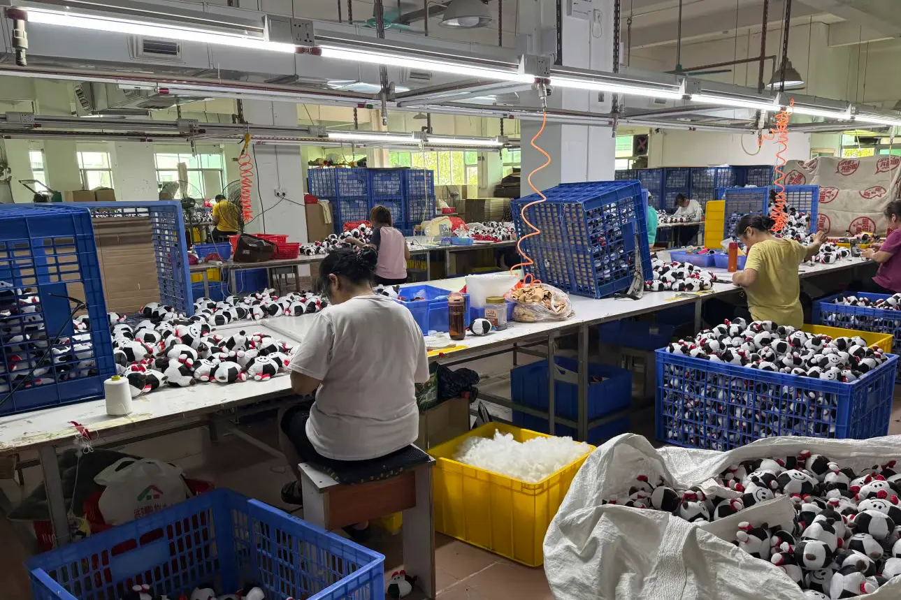 Workers finishing soccer ball plush keychains on factory production tables