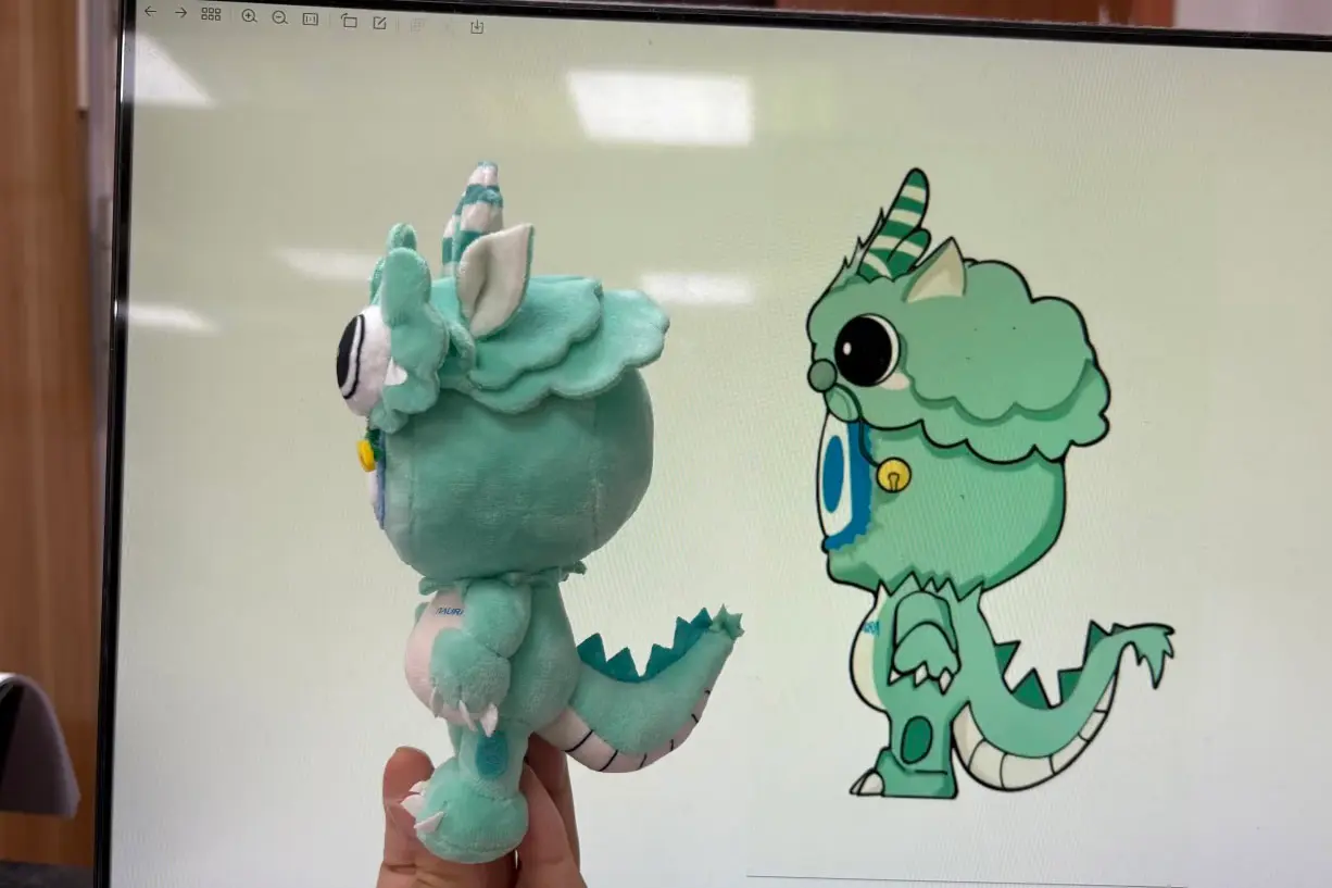 Green dragon plush sample compared with the original character artwork on screen
