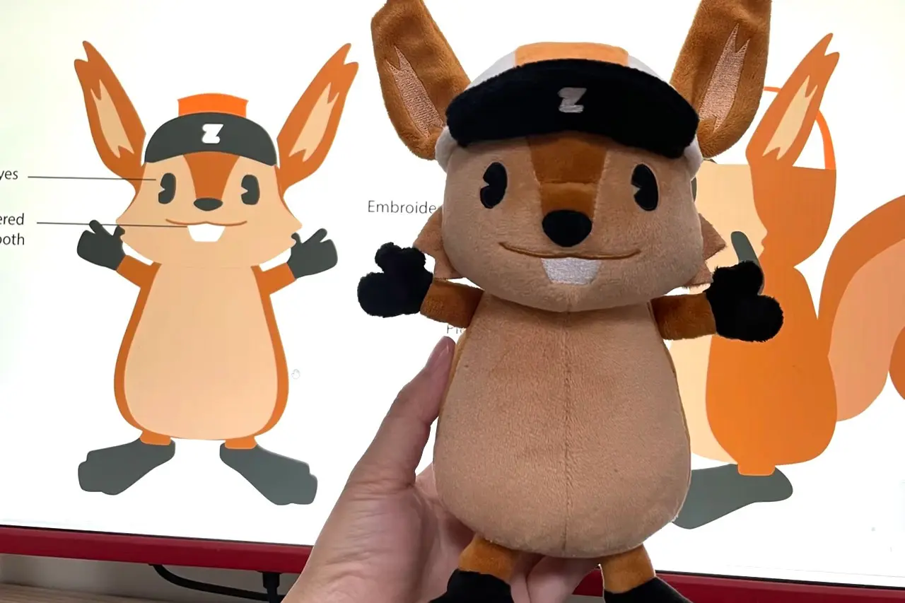Squirrel mascot artwork compared with the finished plush sample shape