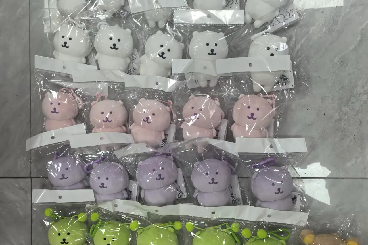 Packaged mini mascot plush keychains in clear bags with hang tags