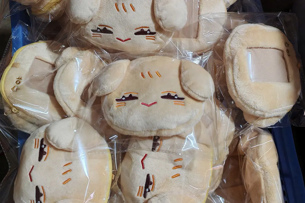 Bunny face plush bags packed in clear poly bags with embroidered faces visible