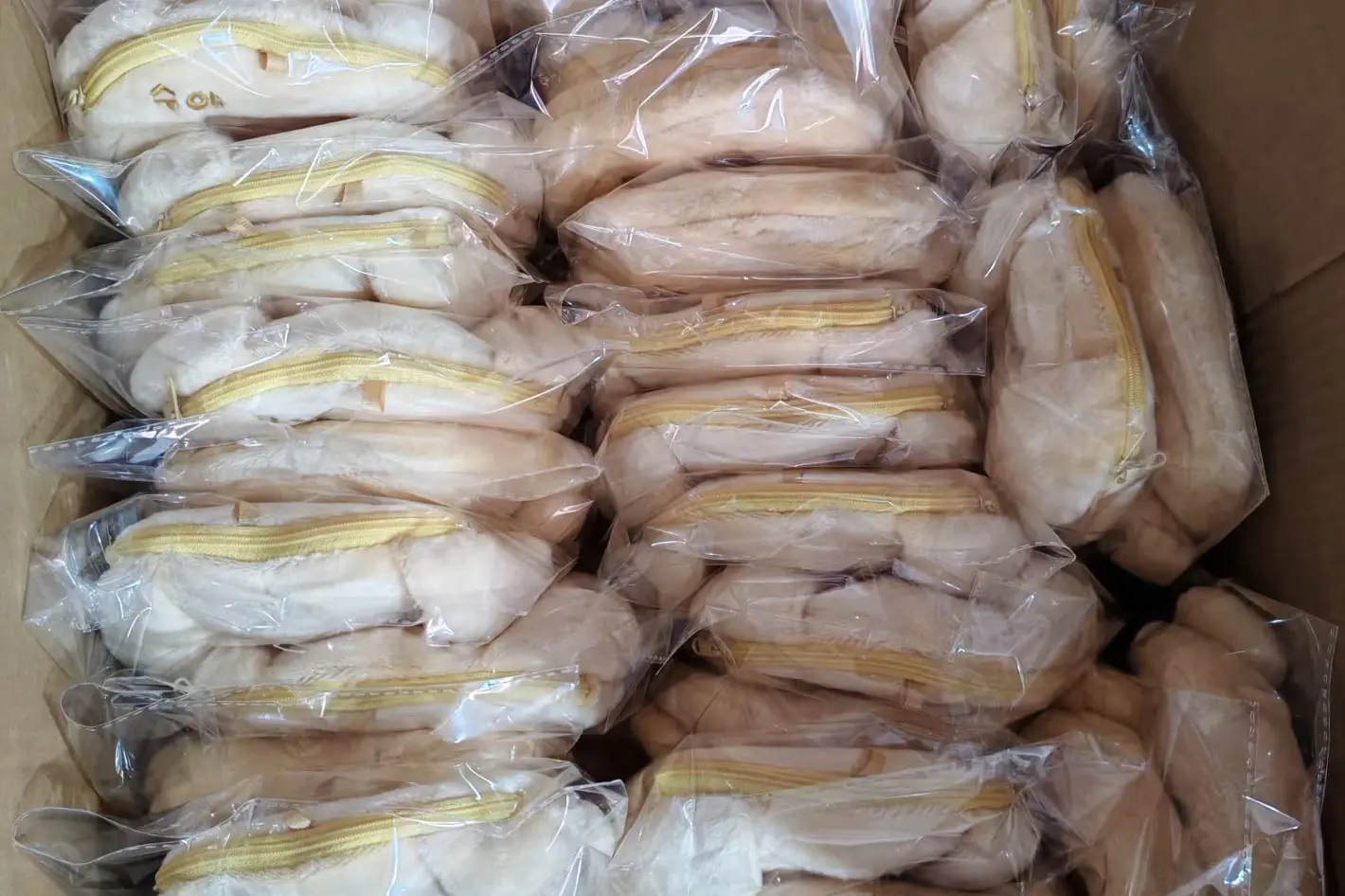 Cream plush bags individually packed in clear OPP bags inside a carton
