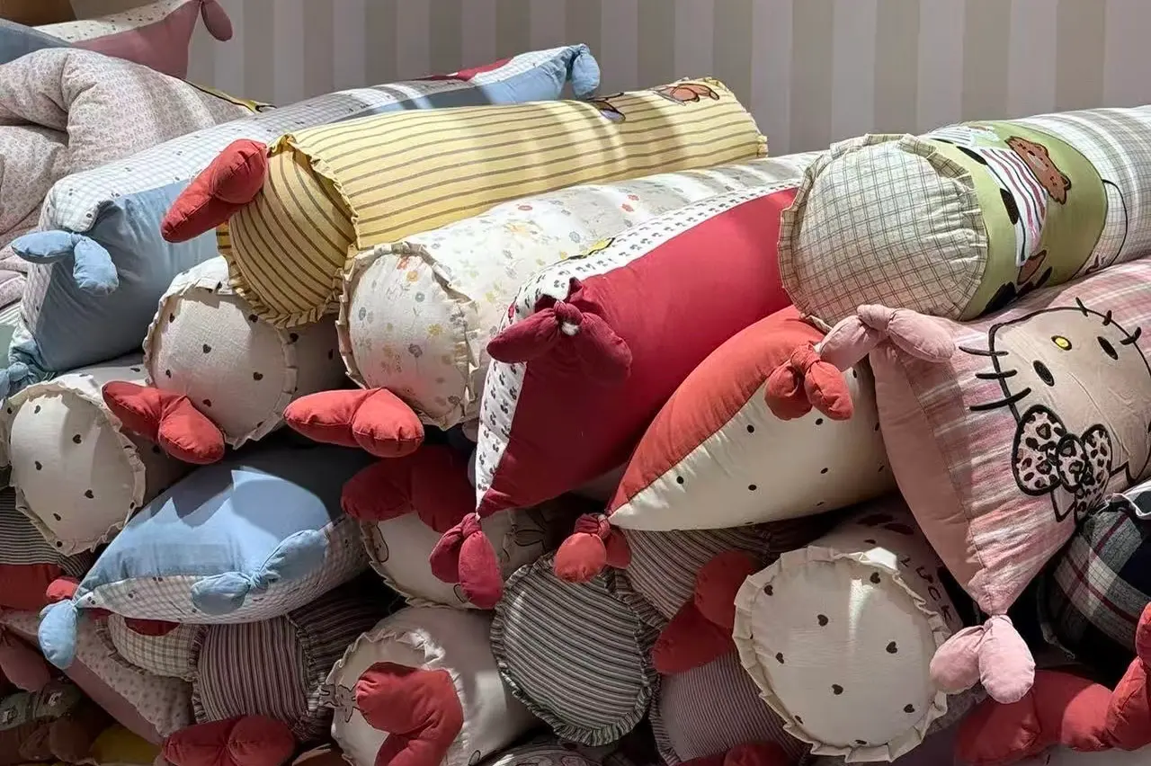 Animal shaped cylinder plush pillows with mixed fabric panels and soft seams