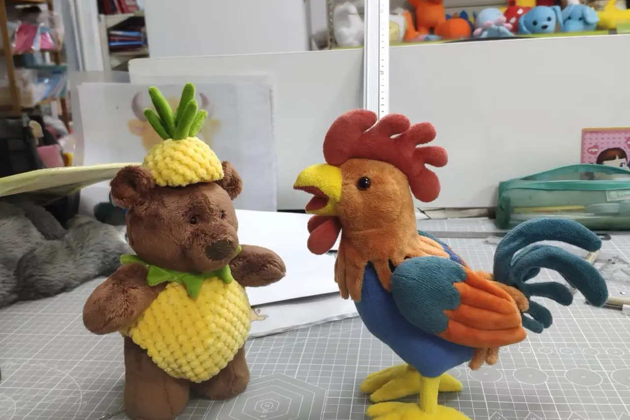 Pineapple bear and rooster stuffed animal samples showing ears, tails, paws, and shape details